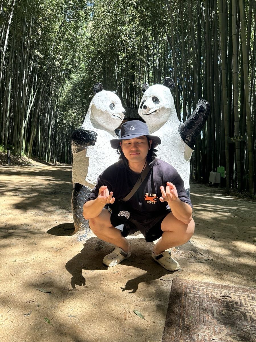 Panda statues among bamboo